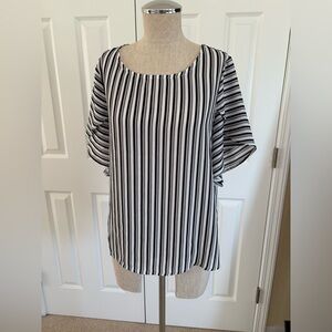 Woman’s flutter sleeve blouse! Super flattering!
